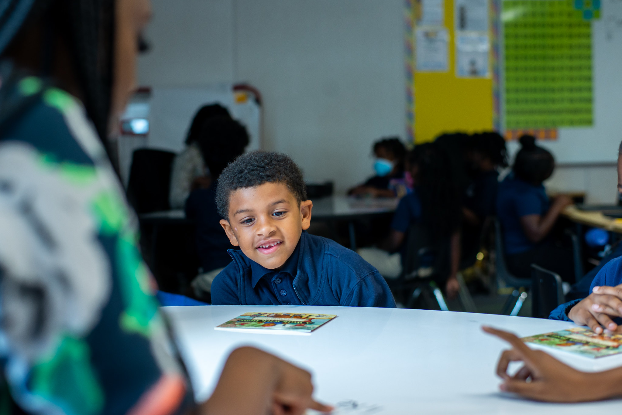 young student in classroom sitting and smiling