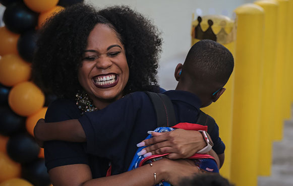 teacher and young student smiling