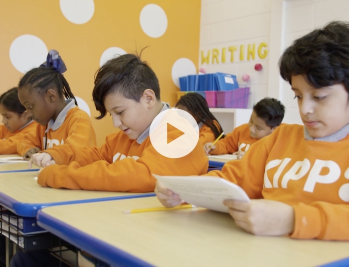 children in classroom reading at their desks