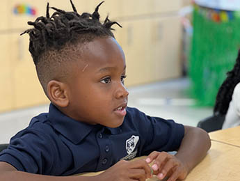 young student in classroom looking forward