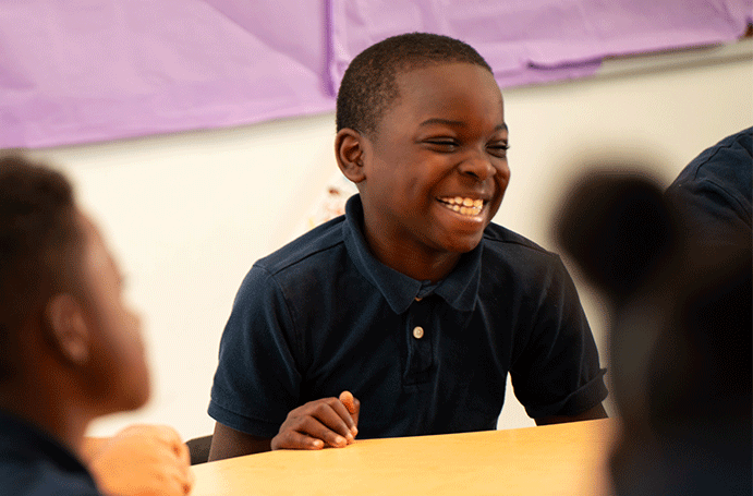 student smiling in classroom