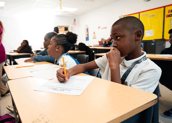 student focused and writing in classroom