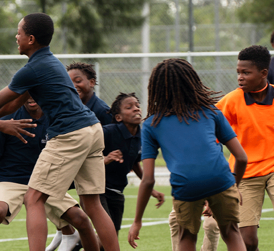 middle school students playing football